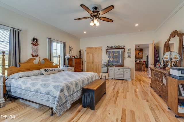 bedroom with crown molding, light wood-type flooring, and ceiling fan