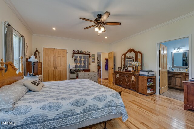 bedroom with ornamental molding, light hardwood / wood-style flooring, ceiling fan, and ensuite bath