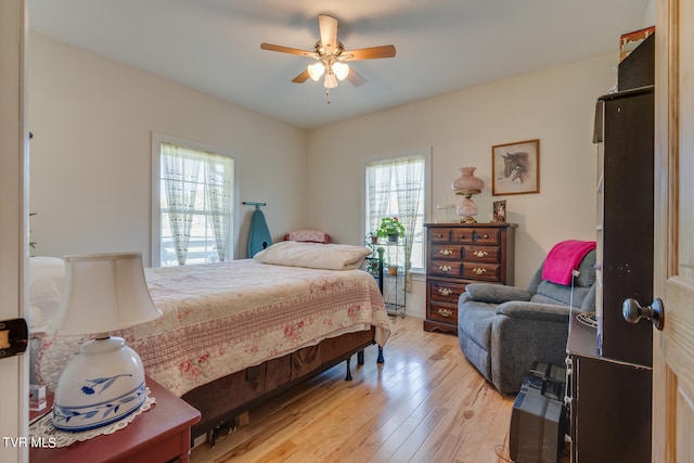 bedroom with light hardwood / wood-style flooring, multiple windows, and ceiling fan