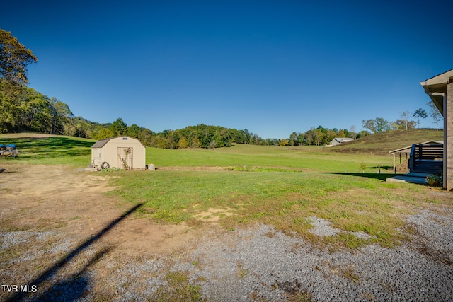 view of yard featuring a storage unit and a rural view