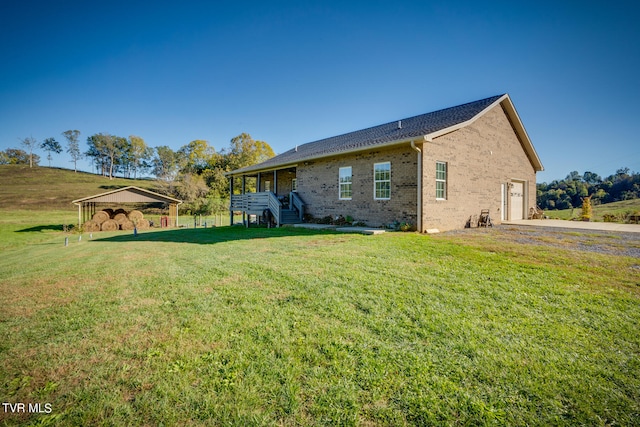 rear view of house with a gazebo and a yard