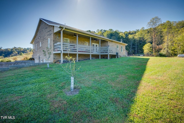 view of front facade featuring a front yard and a wooden deck