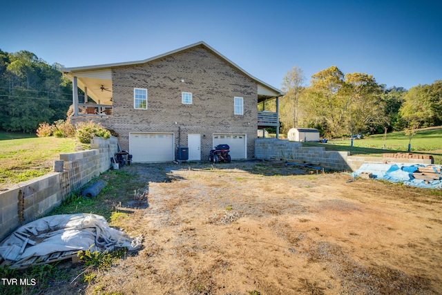 view of side of property with ceiling fan and a garage