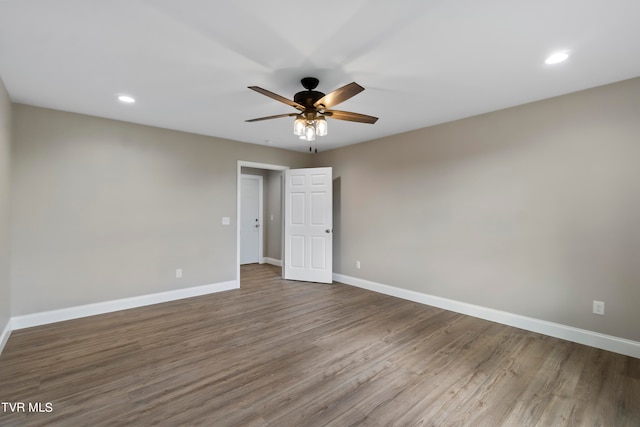 empty room with ceiling fan and wood-type flooring