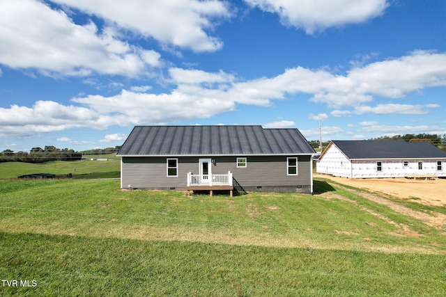 rear view of property with a yard