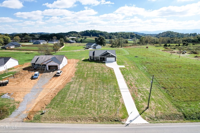 birds eye view of property with a rural view