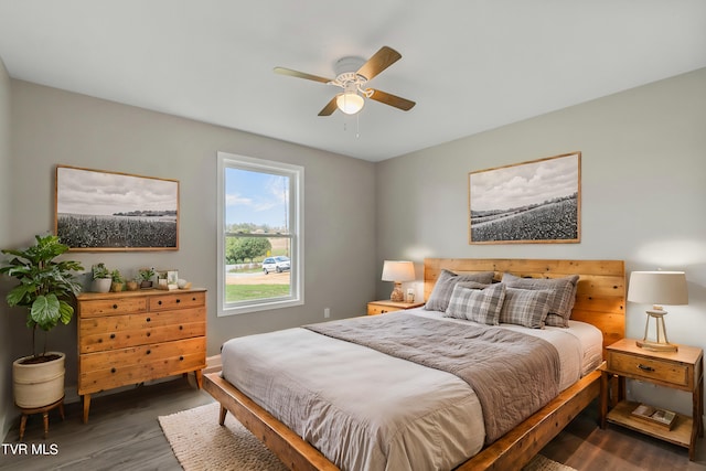 bedroom with ceiling fan and dark hardwood / wood-style flooring