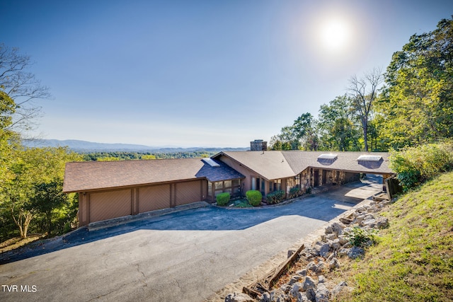 view of front facade with a mountain view and a garage