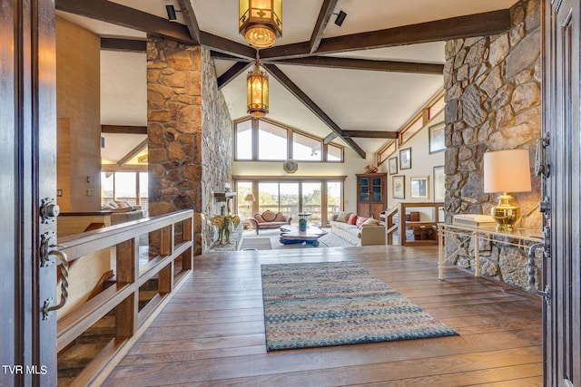 interior space with beam ceiling, wood-type flooring, and high vaulted ceiling