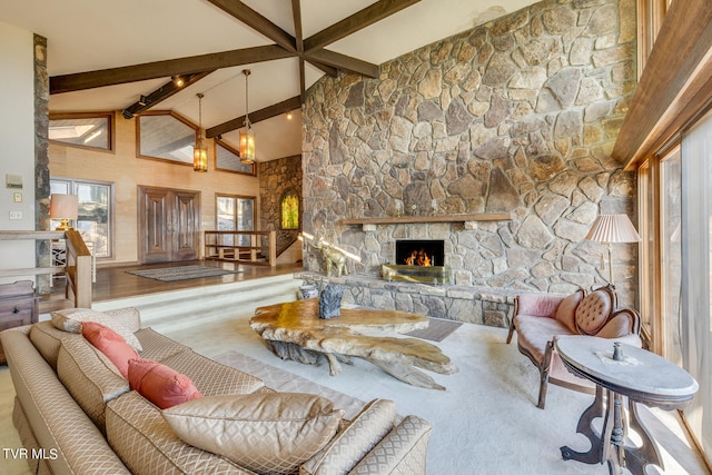 living room featuring plenty of natural light, hardwood / wood-style floors, beamed ceiling, and a fireplace