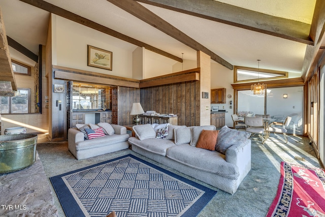 living room featuring a notable chandelier, carpet flooring, beamed ceiling, and high vaulted ceiling