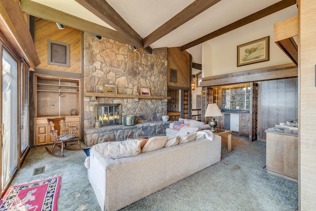 carpeted living room with beam ceiling, a stone fireplace, and high vaulted ceiling