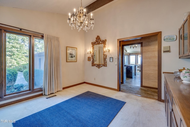 interior space with beam ceiling, a chandelier, light carpet, and a healthy amount of sunlight