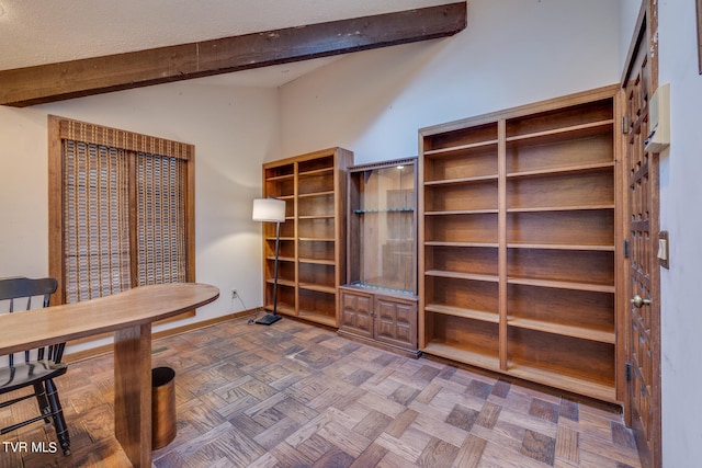 office area with parquet flooring and lofted ceiling with beams