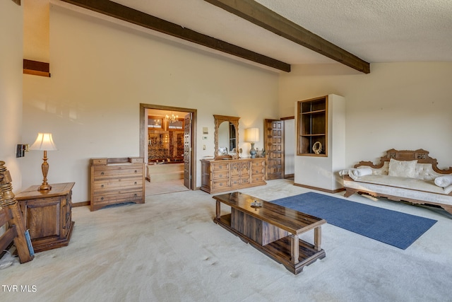 carpeted living room with vaulted ceiling with beams and a textured ceiling