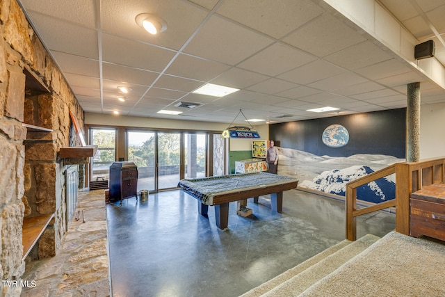 rec room featuring concrete flooring, a paneled ceiling, and billiards