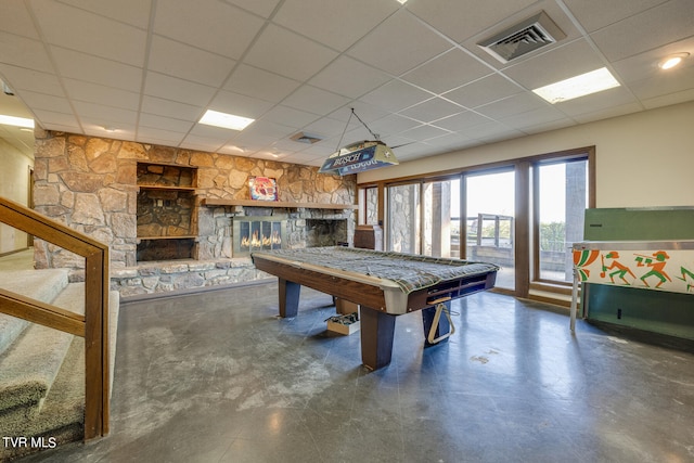 game room featuring a stone fireplace, a paneled ceiling, and billiards