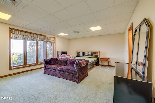 bedroom with light carpet and a paneled ceiling