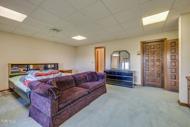 carpeted bedroom with a drop ceiling