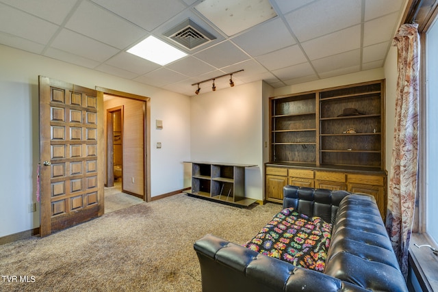 carpeted living room featuring a paneled ceiling