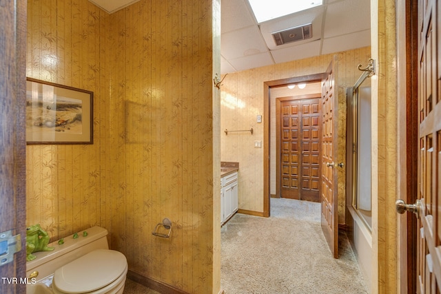 full bathroom featuring toilet, a paneled ceiling, shower / tub combination, and vanity