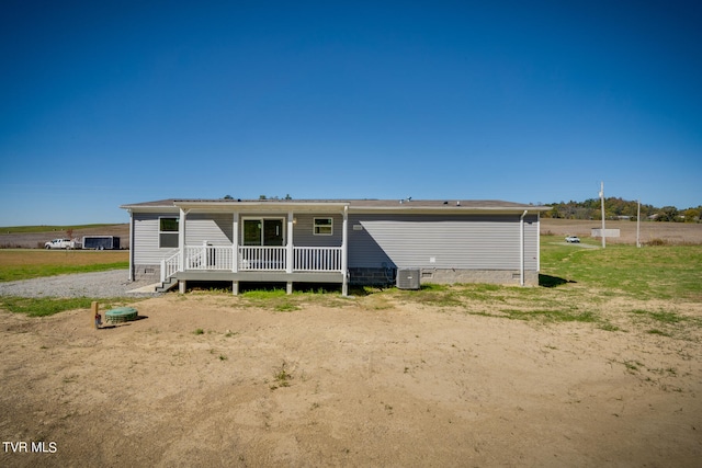 rear view of property featuring central AC