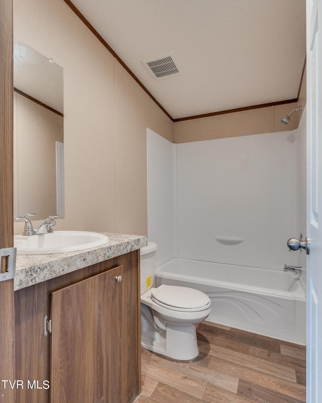 full bathroom with vanity, shower / tub combination, toilet, and wood-type flooring