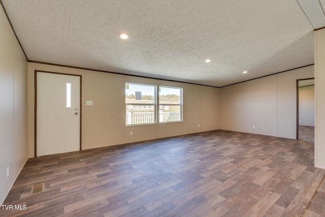 interior space featuring a textured ceiling and hardwood / wood-style flooring