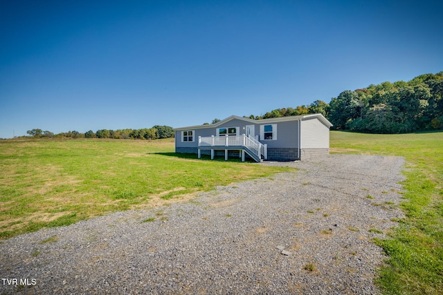 manufactured / mobile home featuring a front yard and a rural view