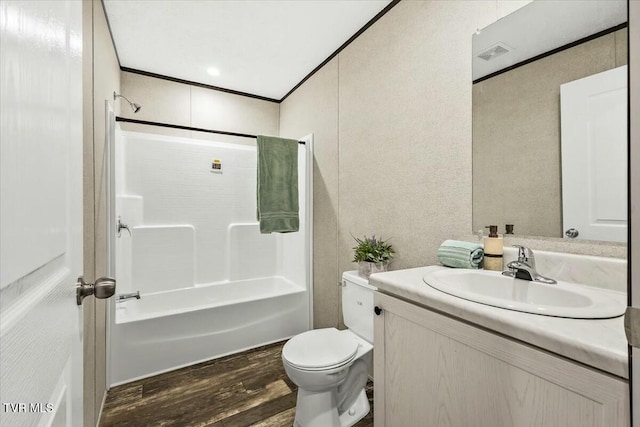 full bathroom with crown molding, toilet, shower / washtub combination, vanity, and hardwood / wood-style flooring