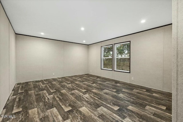 empty room with dark hardwood / wood-style flooring