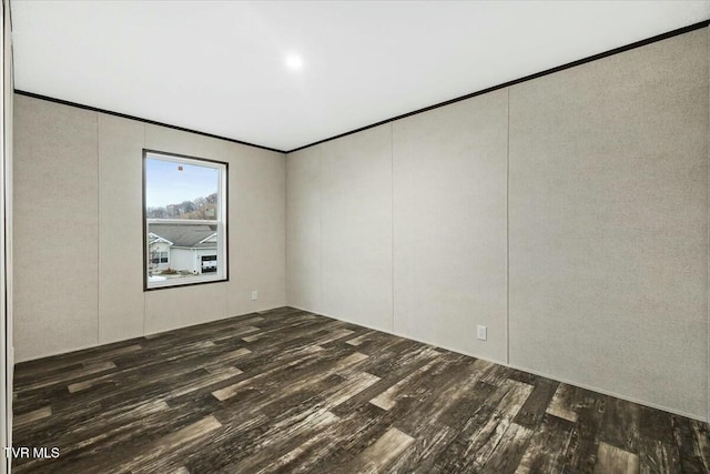 spare room with dark hardwood / wood-style floors and ornamental molding