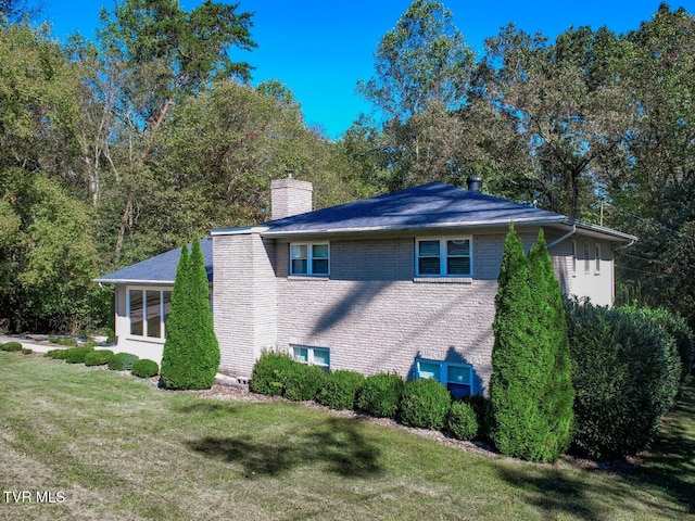 view of side of home featuring a lawn