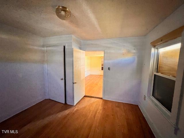 unfurnished room with hardwood / wood-style flooring