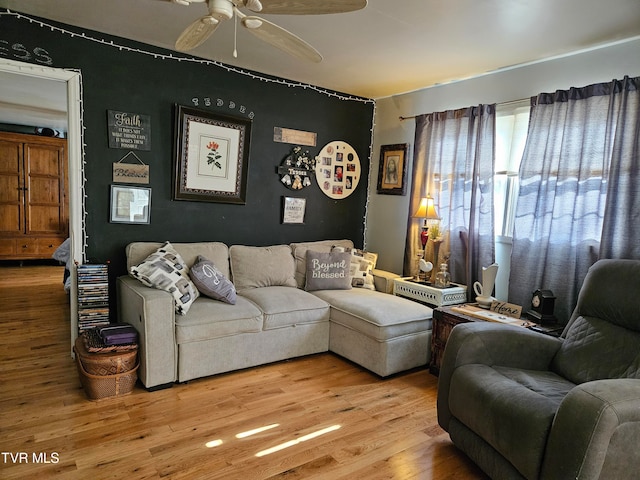 living room featuring light hardwood / wood-style floors and ceiling fan