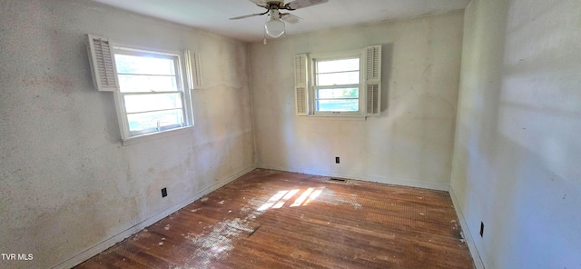 unfurnished room featuring ceiling fan and dark hardwood / wood-style flooring