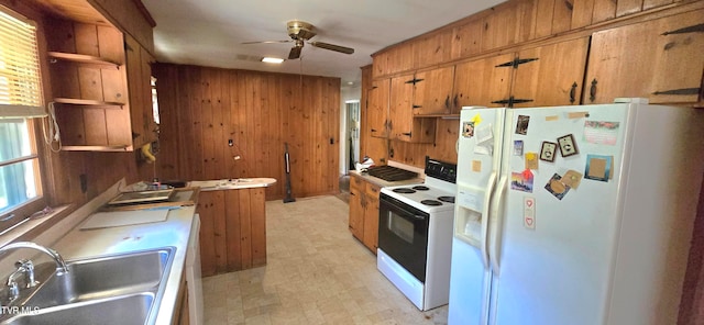 kitchen with wooden walls, sink, ceiling fan, and white appliances