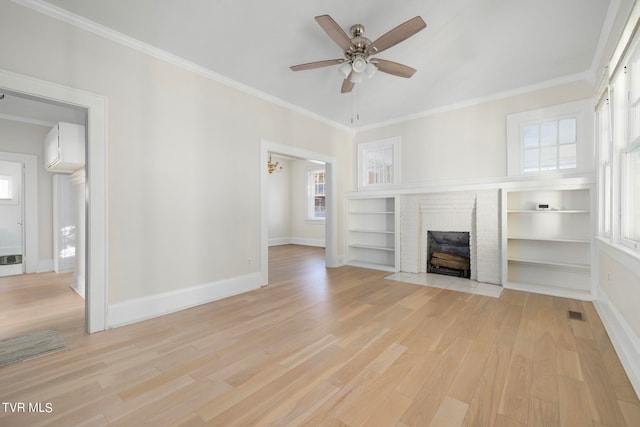 unfurnished living room featuring crown molding, a fireplace, and light hardwood / wood-style floors