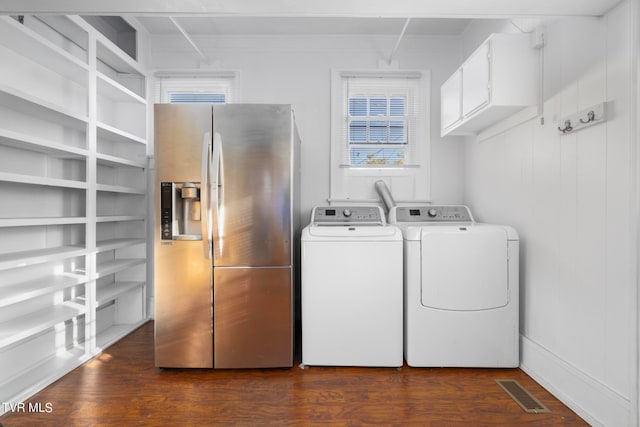 clothes washing area featuring washer and dryer and dark hardwood / wood-style flooring