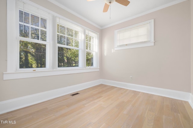 empty room with light hardwood / wood-style floors, ornamental molding, and ceiling fan