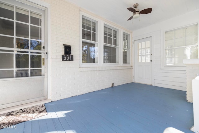 doorway to property featuring ceiling fan