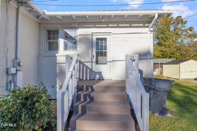 entrance to property with a lawn