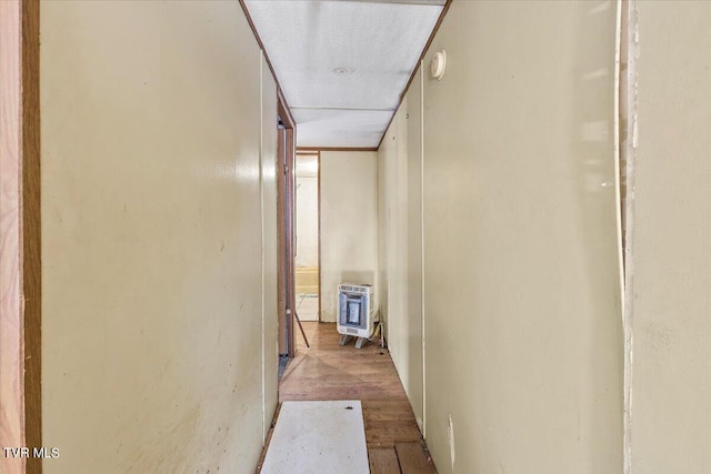 hall featuring heating unit and light hardwood / wood-style flooring