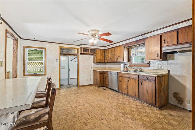 kitchen featuring light parquet flooring, sink, ceiling fan, stainless steel dishwasher, and crown molding