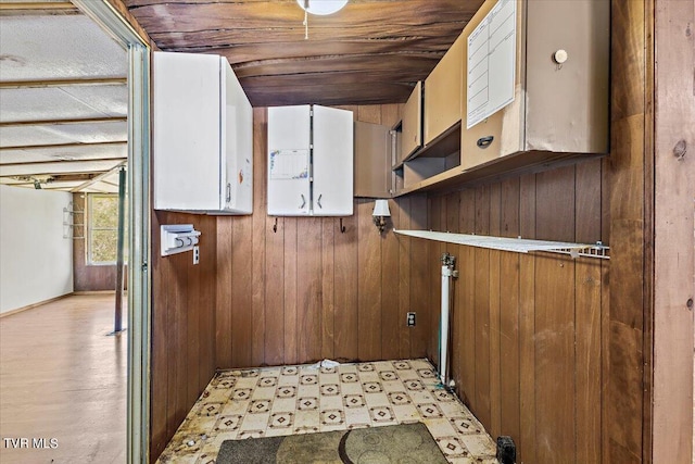 laundry room featuring wood walls and wooden ceiling