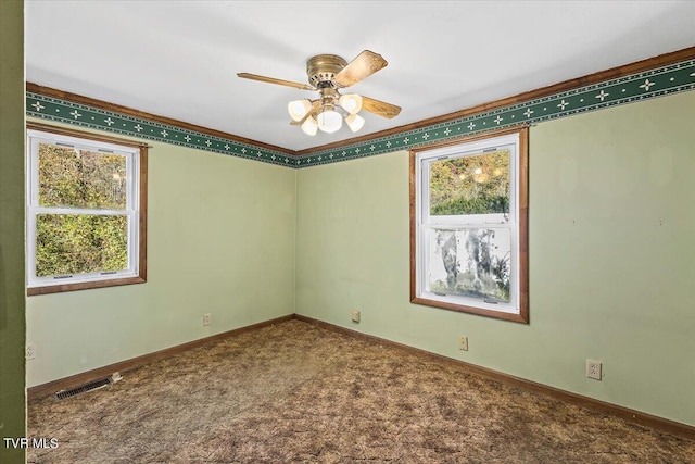 unfurnished room with ceiling fan, carpet, and a wealth of natural light