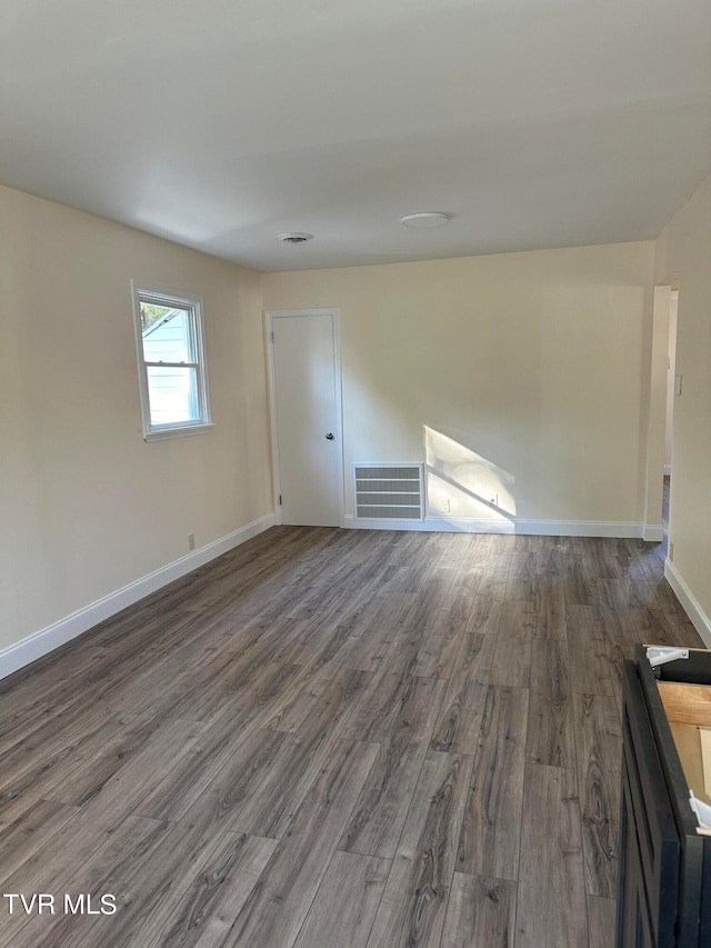 spare room with dark hardwood / wood-style flooring