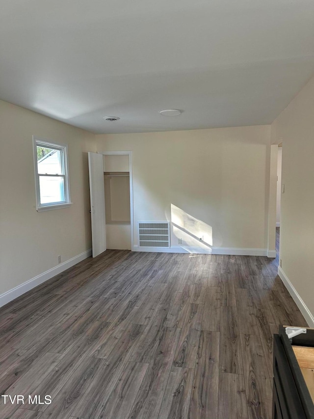 spare room featuring dark wood-type flooring