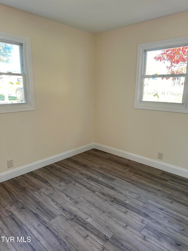 unfurnished room featuring hardwood / wood-style flooring