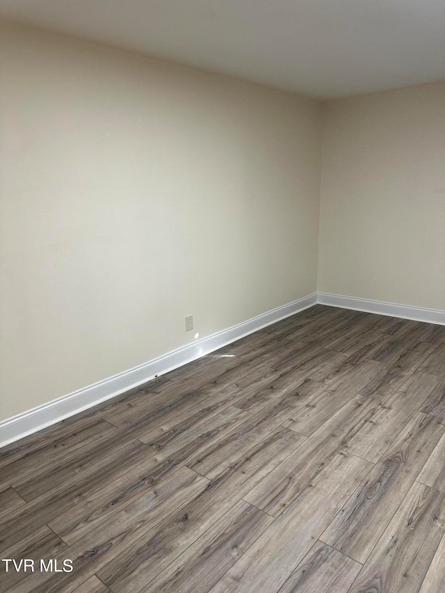 empty room with dark hardwood / wood-style floors